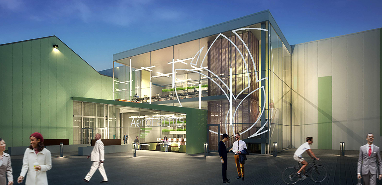 Rendering of the exterior of the AeroFarms building in the evening with the windows lit up.